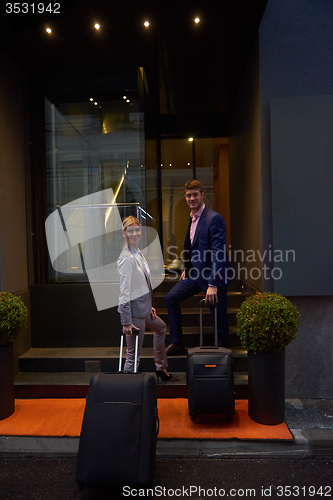 Image of business people couple entering  hotel