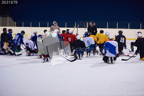 Image of ice hockey players team meeting with trainer