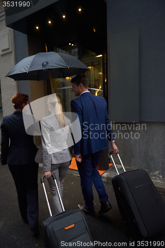 Image of business people couple entering  hotel