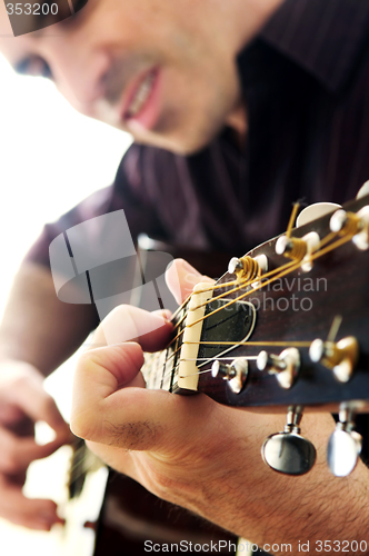 Image of Man playing a guitar