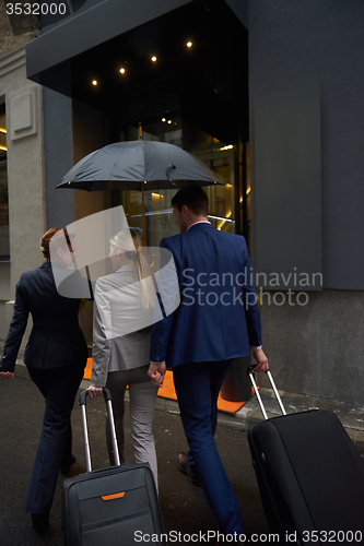 Image of business people couple entering  hotel