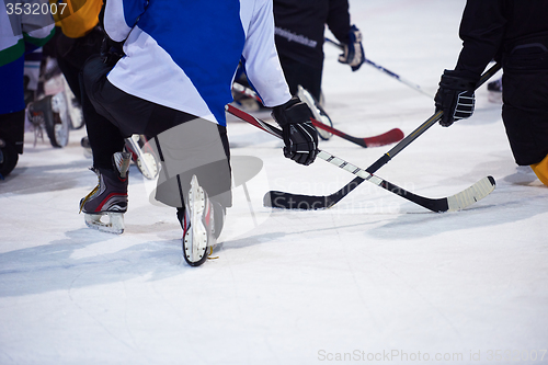 Image of ice hockey players team meeting with trainer