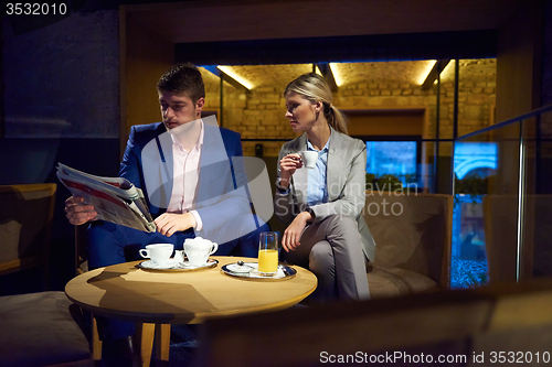 Image of business couple take drink after work