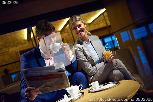 Image of business couple take drink after work