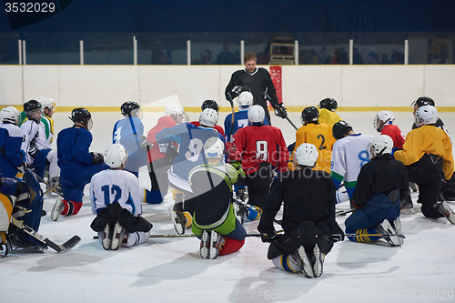Image of ice hockey players team meeting with trainer