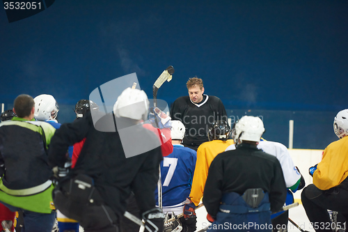 Image of ice hockey players team meeting with trainer