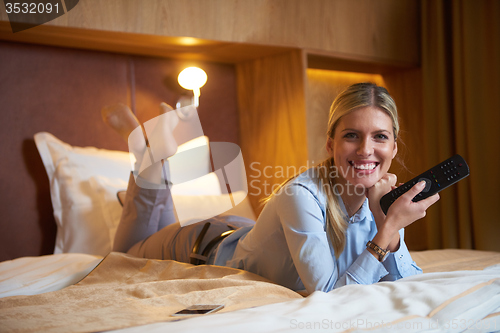 Image of young business woman relaxing in hotel room