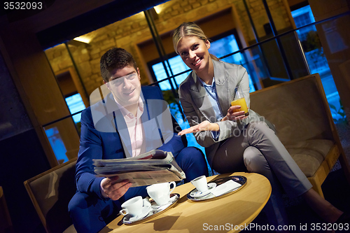 Image of business couple take drink after work