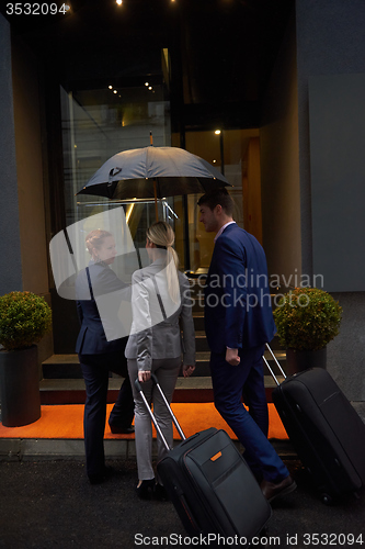 Image of business people couple entering  hotel