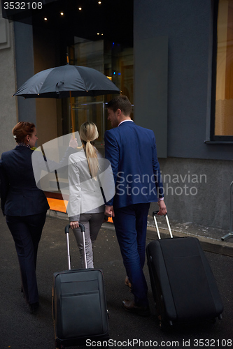 Image of business people couple entering  hotel