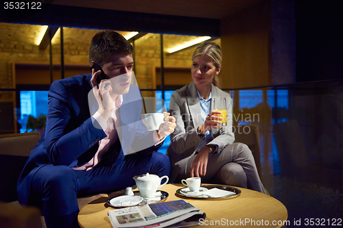 Image of business couple take drink after work