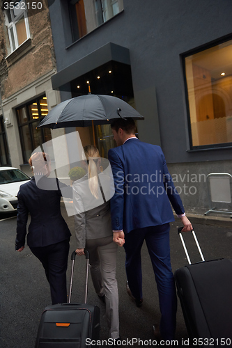 Image of business people couple entering  hotel