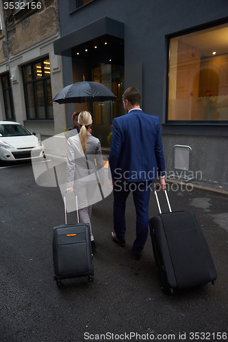 Image of business people couple entering  hotel