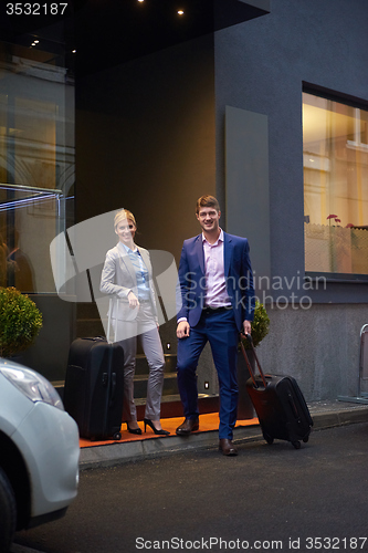 Image of business people couple entering  hotel