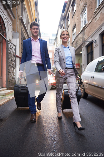 Image of business people couple entering  hotel