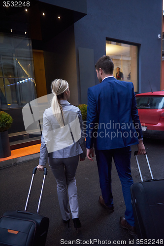 Image of business people couple entering  hotel