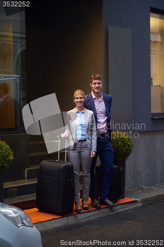 Image of business people couple entering  hotel