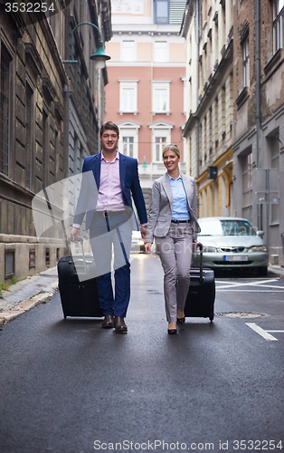 Image of business people couple entering  hotel