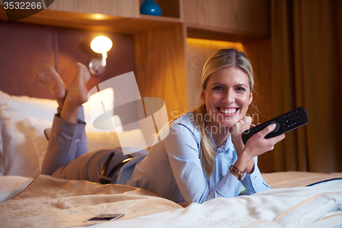 Image of young business woman relaxing in hotel room