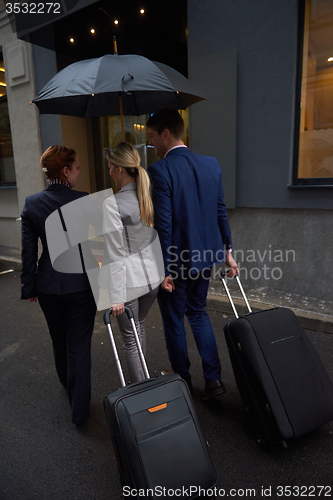 Image of business people couple entering  hotel