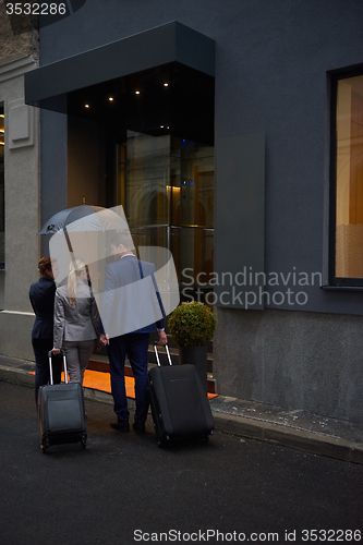 Image of business people couple entering  hotel