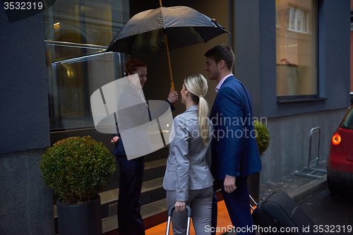 Image of business people couple entering  hotel