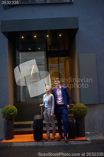 Image of business people couple entering  hotel