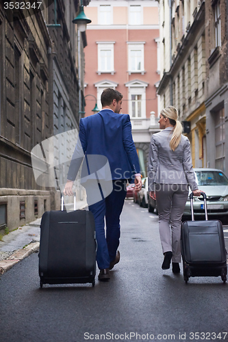 Image of business people couple entering  hotel