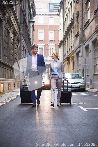 Image of business people couple entering  hotel