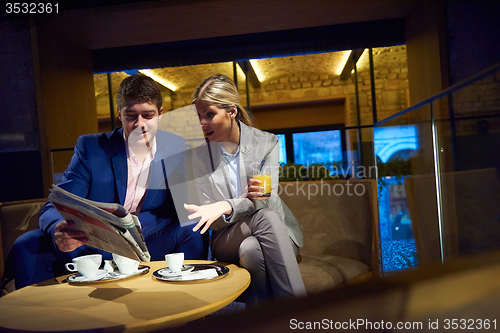 Image of business couple take drink after work