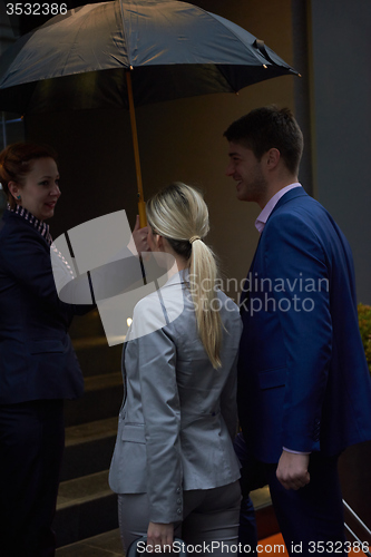 Image of business people couple entering  hotel