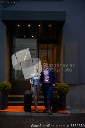 Image of business people couple entering  hotel