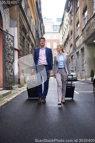 Image of business people couple entering  hotel