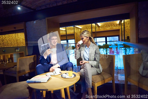 Image of business couple take drink after work