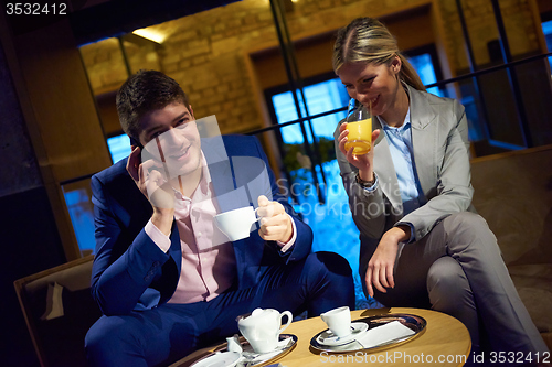 Image of business couple take drink after work