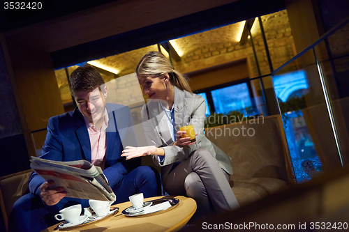 Image of business couple take drink after work