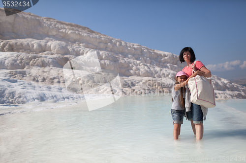 Image of Mother and daughter on background of limestone of Pamukkale, Tur