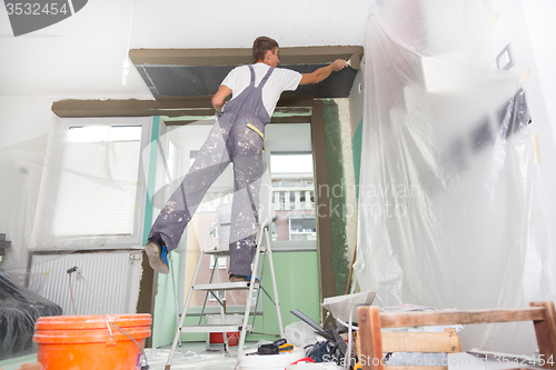 Image of Plasterer renovating indoor walls and ceilings.