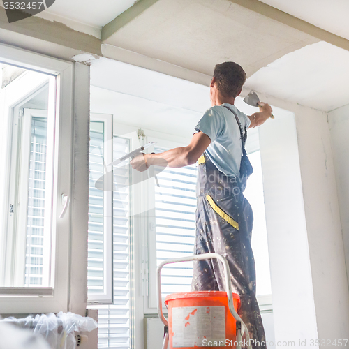 Image of Plasterer renovating indoor walls and ceilings.