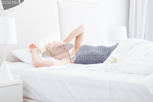 Image of Young beautiful woman refuses to wake up.