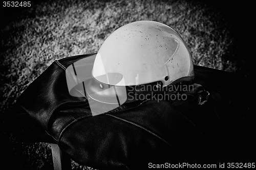 Image of black leather jacket white motorcycle helmet