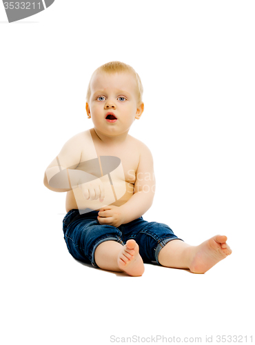Image of baby sitting on the floor. Studio. isolated