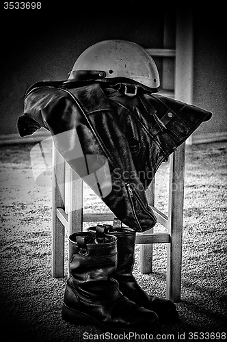 Image of black leather jacket white motorcycle helmet and boots