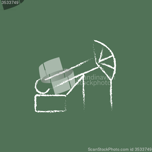 Image of Pump jack oil crane icon drawn in chalk.