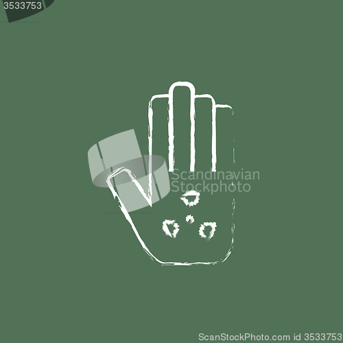 Image of Ionizing radiation sign on a palm icon drawn in chalk.