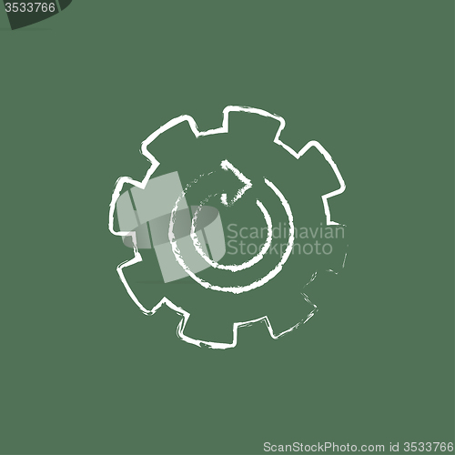 Image of Gear wheel with arrow icon drawn in chalk.