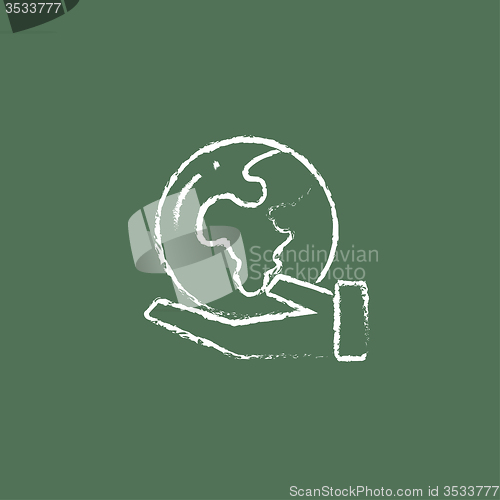 Image of Hand holding the Earth icon drawn in chalk.
