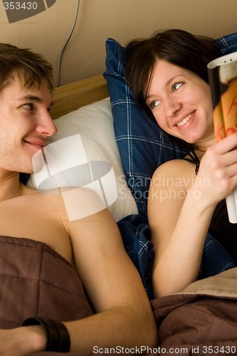 Image of young happy couple in bedroom