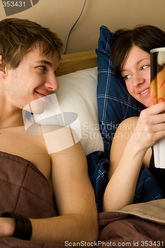 Image of young happy couple in bedroom