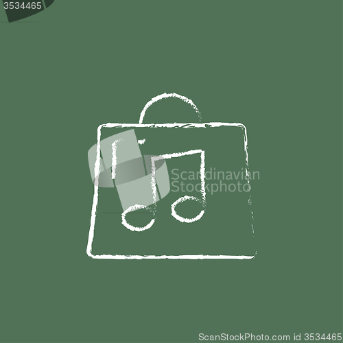 Image of Bag with music note icon drawn in chalk.